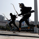 Protesters raced with bows as they practice running away from riot police.